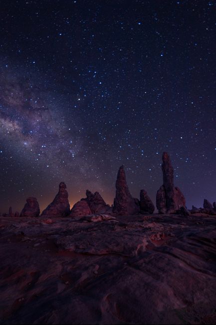 A breathtaking view of AlUla's rock formations under a star-studded night sky in Saudi Arabia.