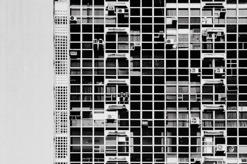 Free Black and white photograph of a building with windows Stock Photo