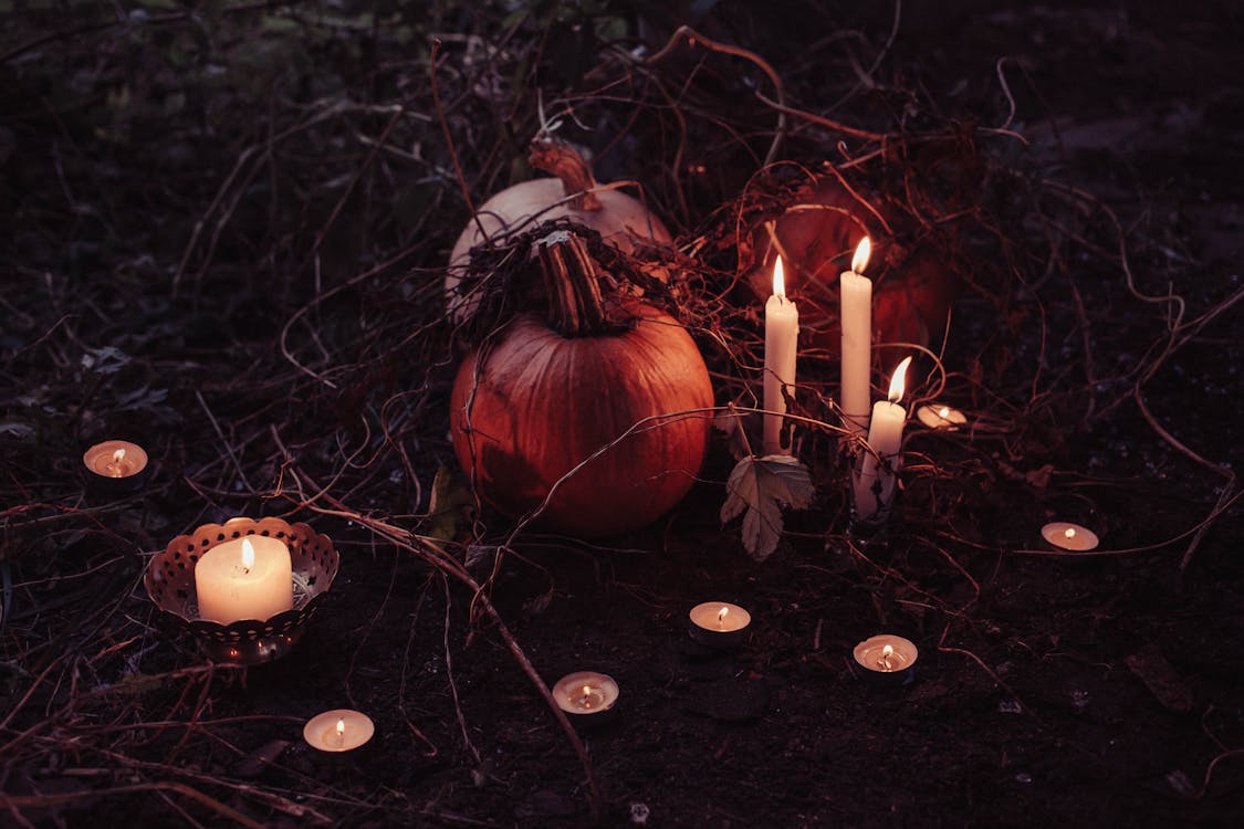 Free Jack O Lantern Beside Candles Halloween Decor Stock Photo