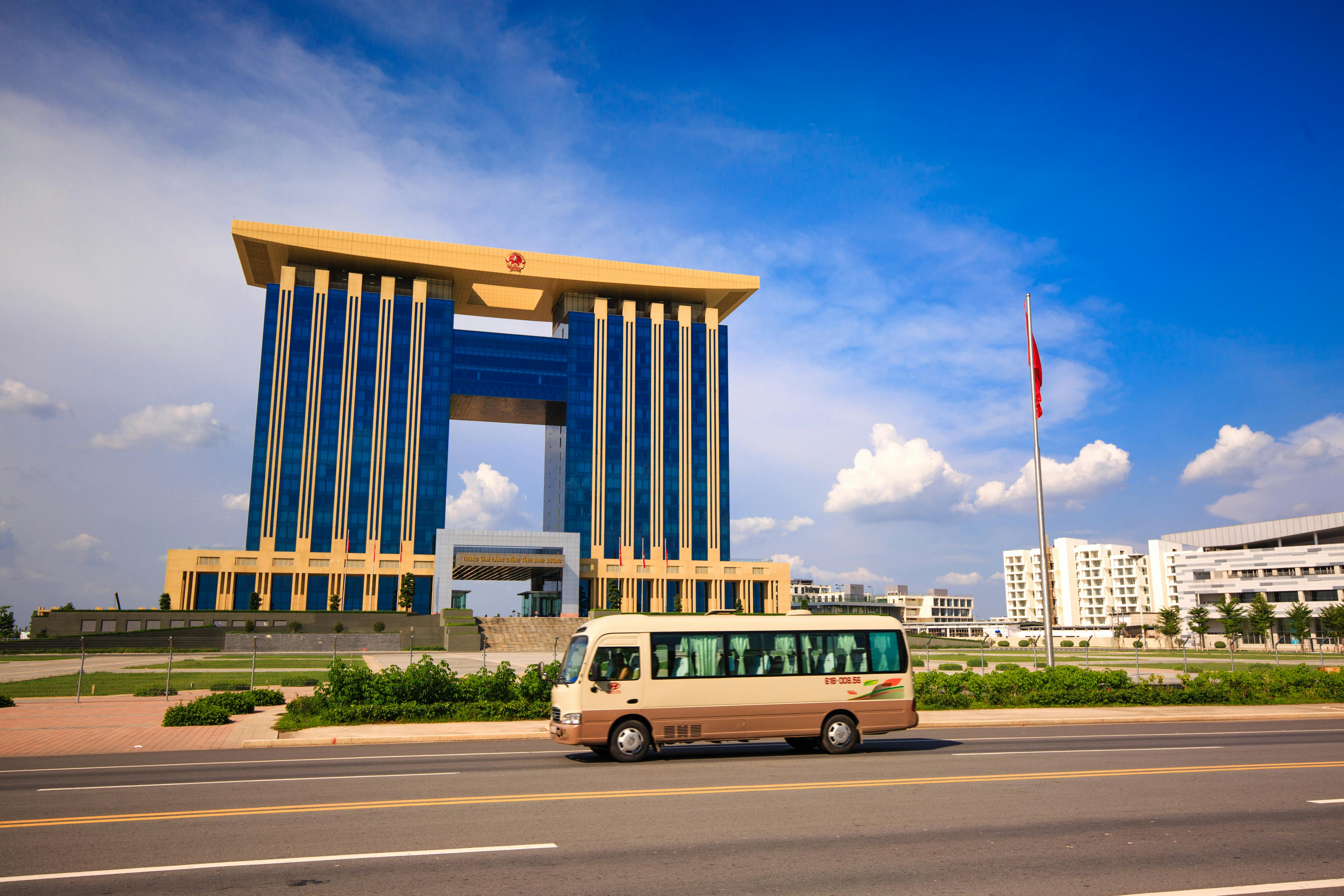 bus on road near brown and blue building