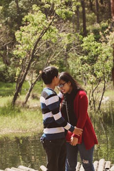 一对年轻夫妇在绿树成荫的宁静户外深情相拥