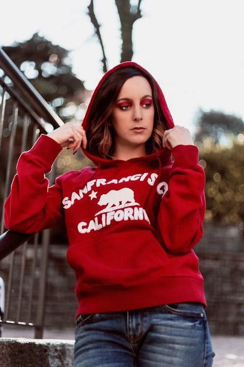 Woman In A Red Pull-up Hooded Sweater