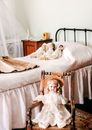 Three Dolls Lying on Bed