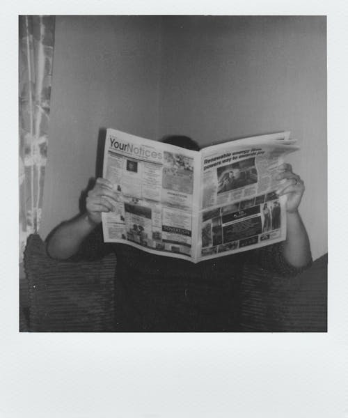 Grayscale Photography Of Man Reading Newspaper