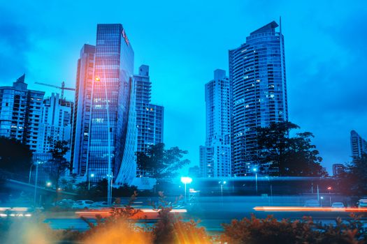 Dramatic view of Panama City's skyline with modern skyscrapers illuminated at night.
