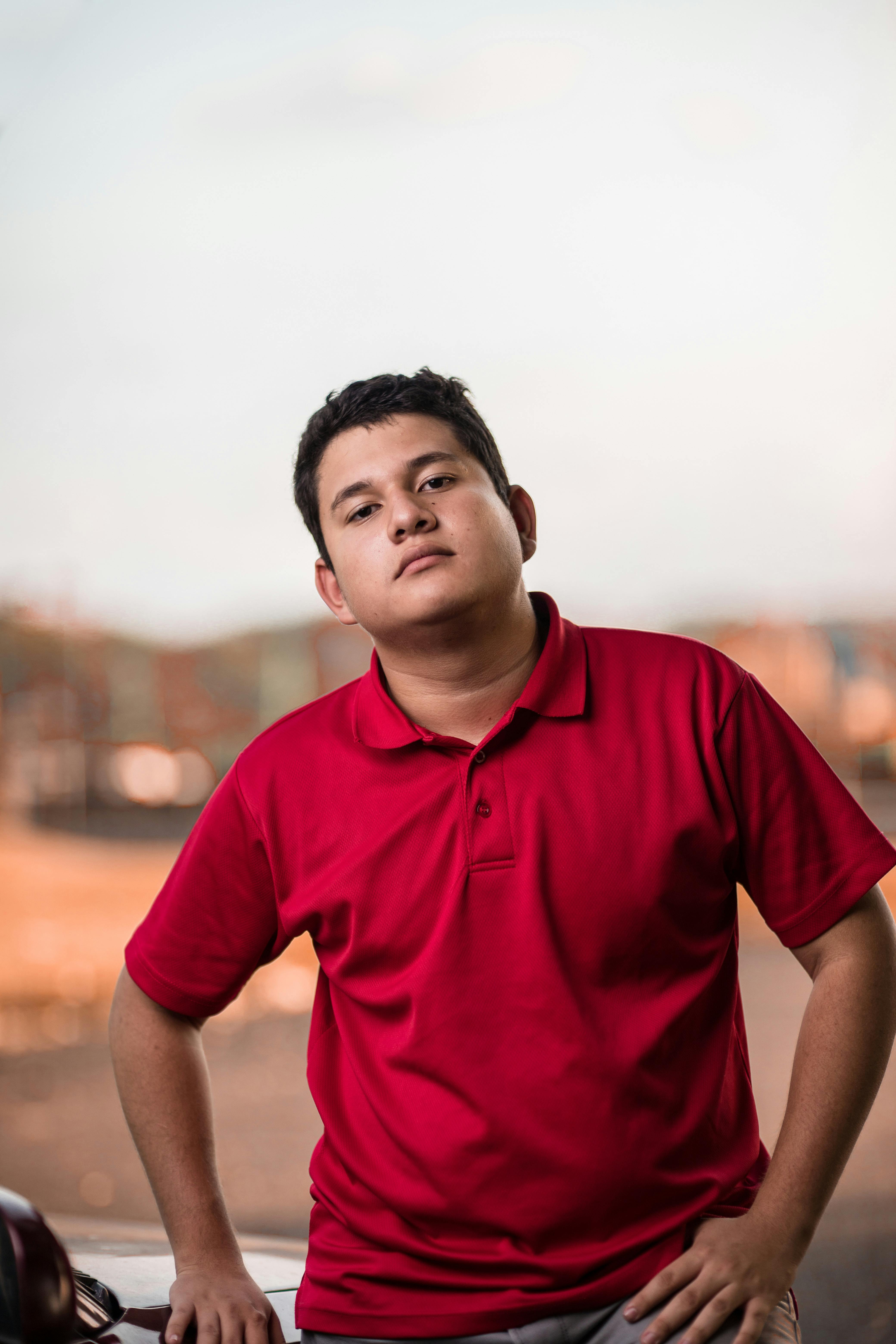 man wearing red polo shirt