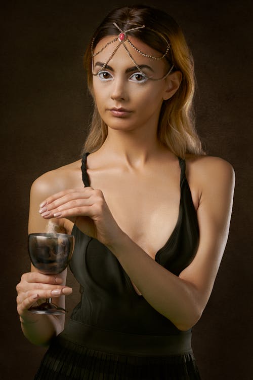 Woman Wearing Black Spaghetti-strap Dress Holding Wine Glass