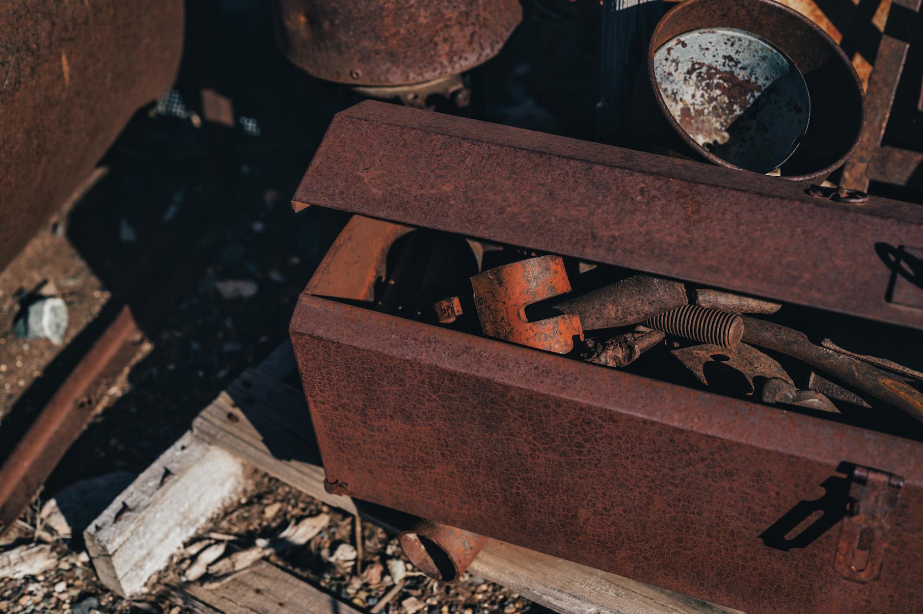 A rusty box with a bunch of rusty tools