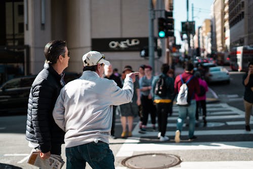 Two Men Walking Near Pedestrian Lane