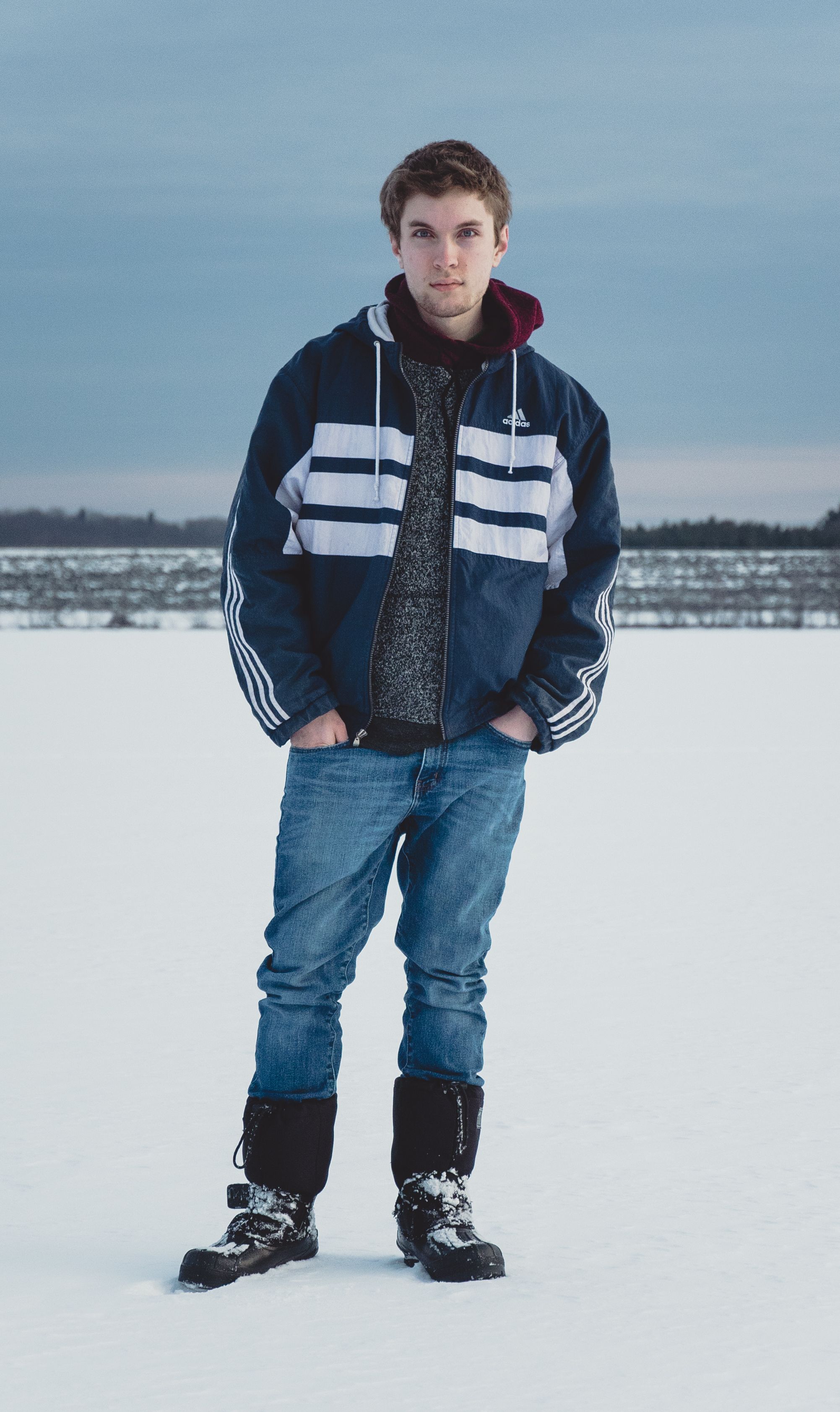 Young Man in Winter Clothing on Snowy Field · Free Stock Photo