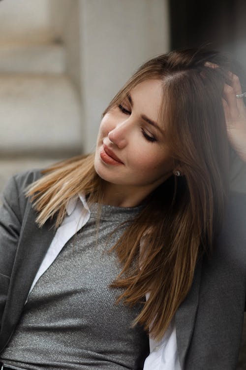 Free A woman with long hair and a grey shirt Stock Photo