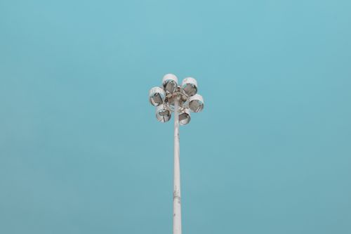 Free Streetlight pole against a clear blue sky, minimalist and modern vibe, with ample copyspace. Stock Photo