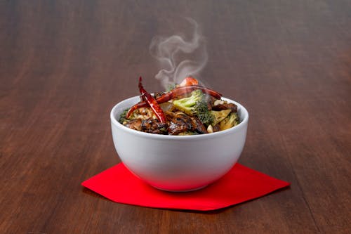 A bowl of food with smoke coming out of it