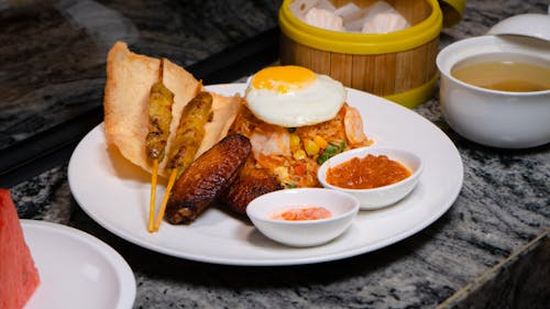 Free A plate of food with a fried egg and a bowl of water Stock Photo