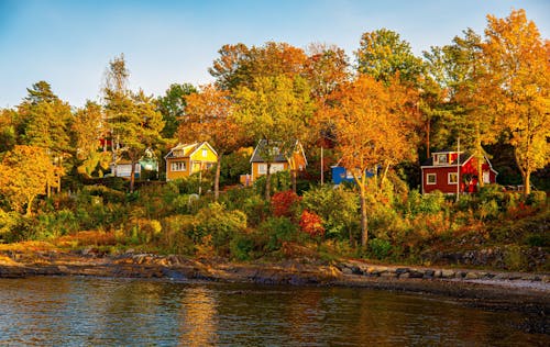 A colorful row of houses on the shore of a lake