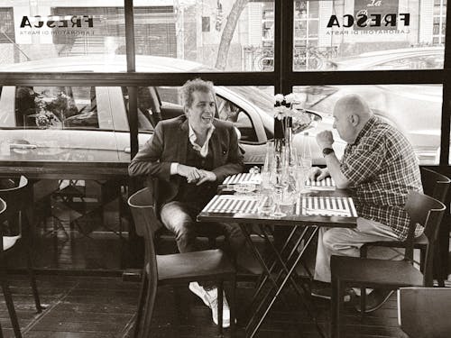 Free Black and White Photography of Men Sitting in a Restaurant Stock Photo