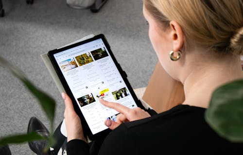 Person browsing a social wall on a tablet and voting on an live poll