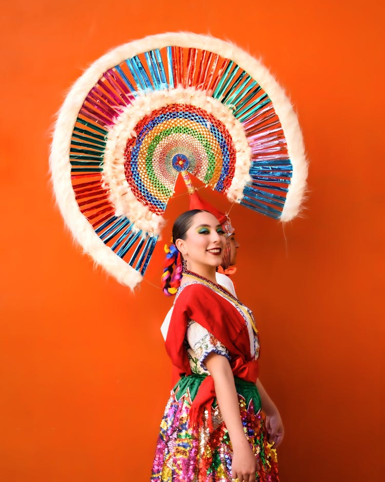 Portrait Of Smiling Brunette Woman In Traditional Clothing And In Hat With Plume