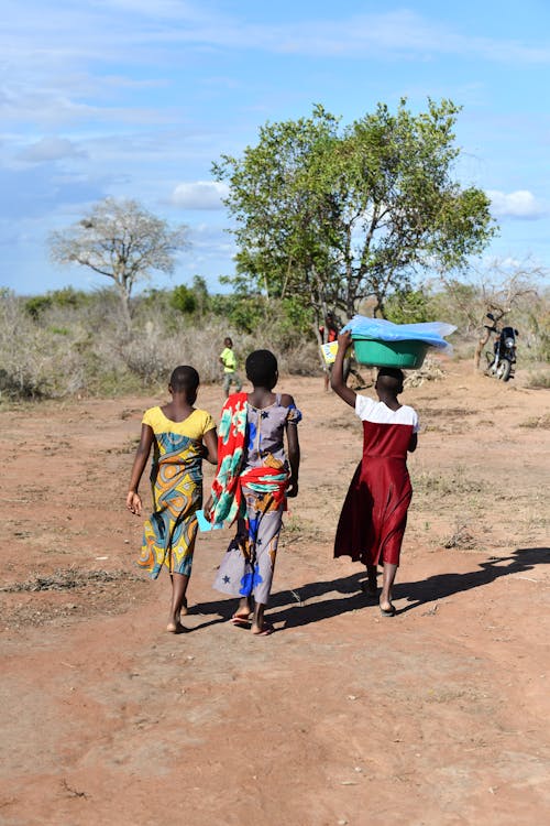 Three women carrying water on their heads