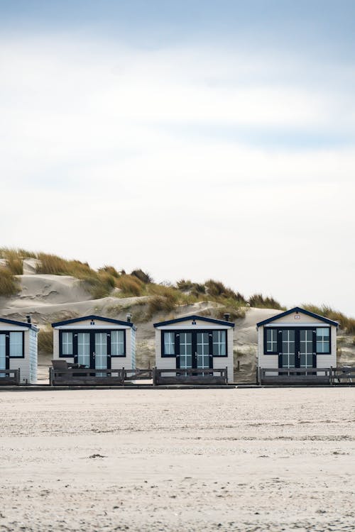 A row of beach huts on a sandy beach