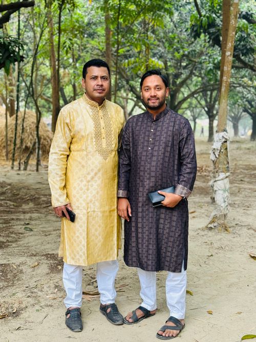 Free Two men wearing traditional clothing posing in a forest setting, depicting cultural fashion. Stock Photo