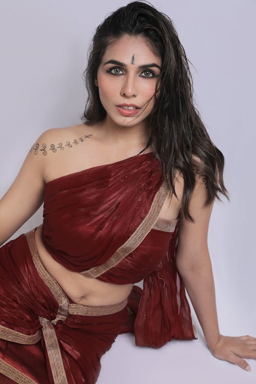 A woman in a red sari posing for the camera