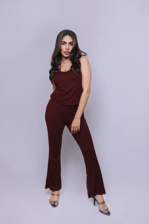 A woman in a burgundy jumpsuit