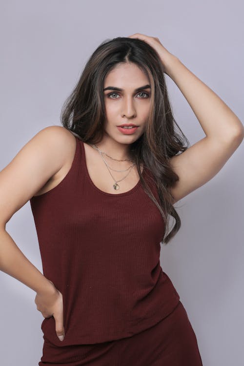 A woman in a burgundy tank top and pants