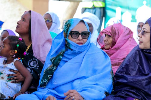 Women in blue and white clothing sitting together