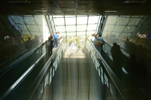 People are riding an escalator in a building