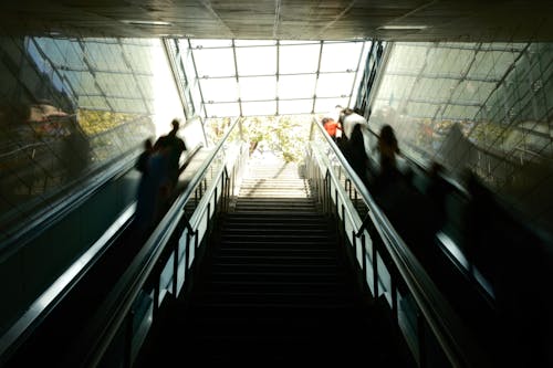 People are riding an escalator in a building