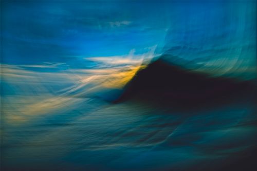 Free A vibrant, abstract seascape capturing the ethereal colors of a sunrise over the ocean. Stock Photo