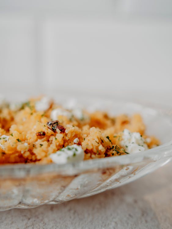 Delicious Couscous with Herbs and Cheese in Plate