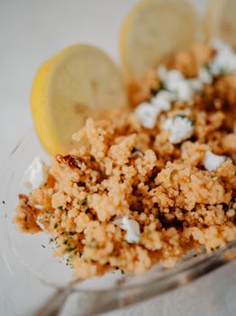 Savory couscous dish garnished with lemon slices and herbs, perfect for a homemade meal.