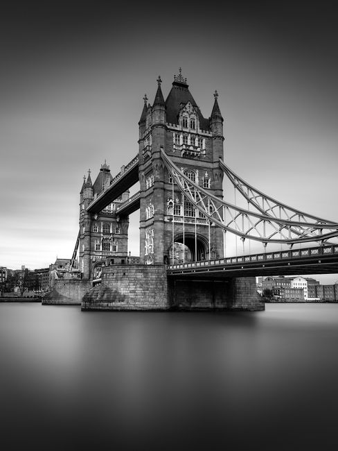 Stunning black and white image of Tower Bridge over the Thames River in London.