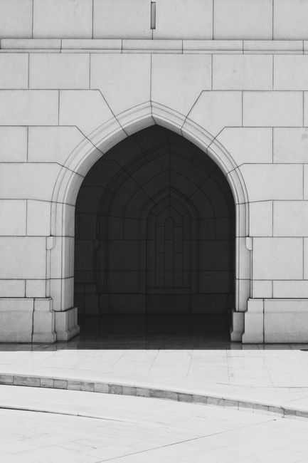 Capture of a classic stone archway facade in Muscat, showcasing elegant architectural design.