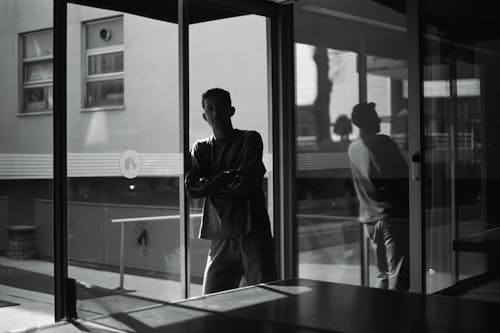 A man standing in front of a glass door