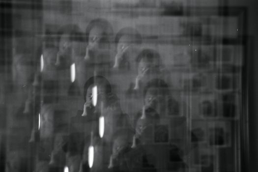 A black and white photo of a man in a mirror