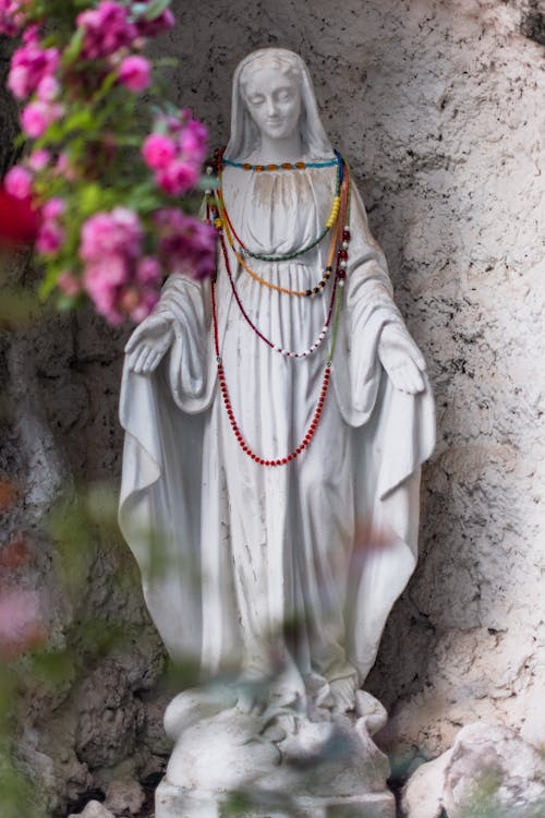 Free A statue of mary with beads around her neck Stock Photo