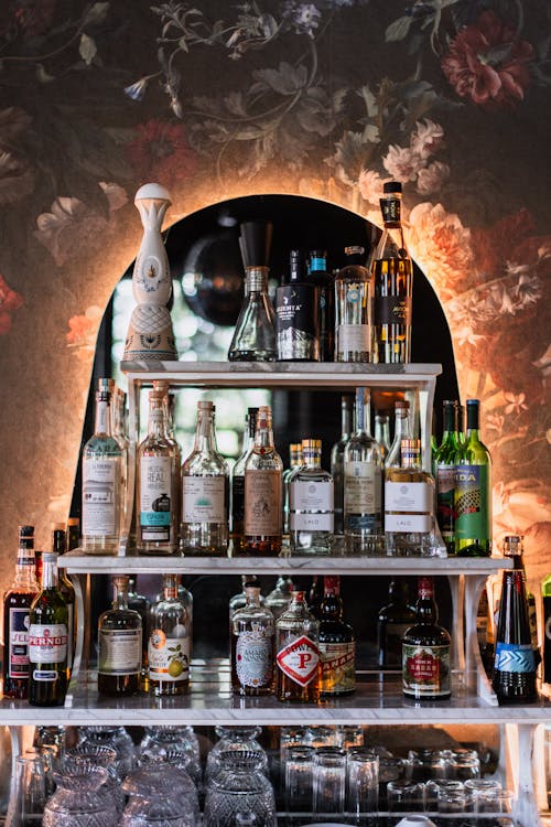 A bar with bottles and glasses on shelves