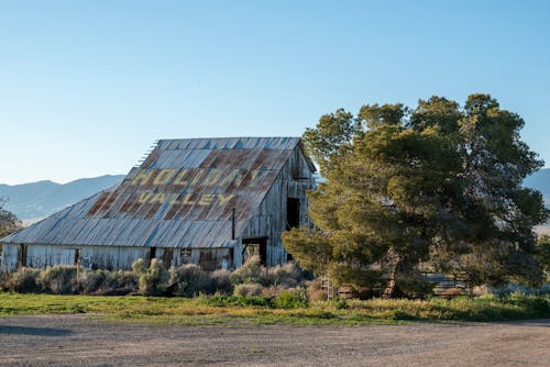 An old barn with a rusty sign on it