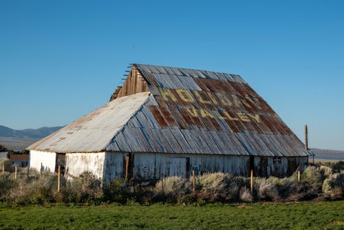 A rusty old barn with a sign on it