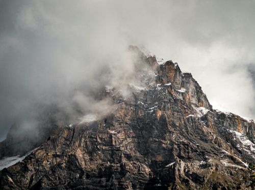 Free A dramatic mountain peak shrouded in clouds, showcasing rugged natural beauty. Stock Photo