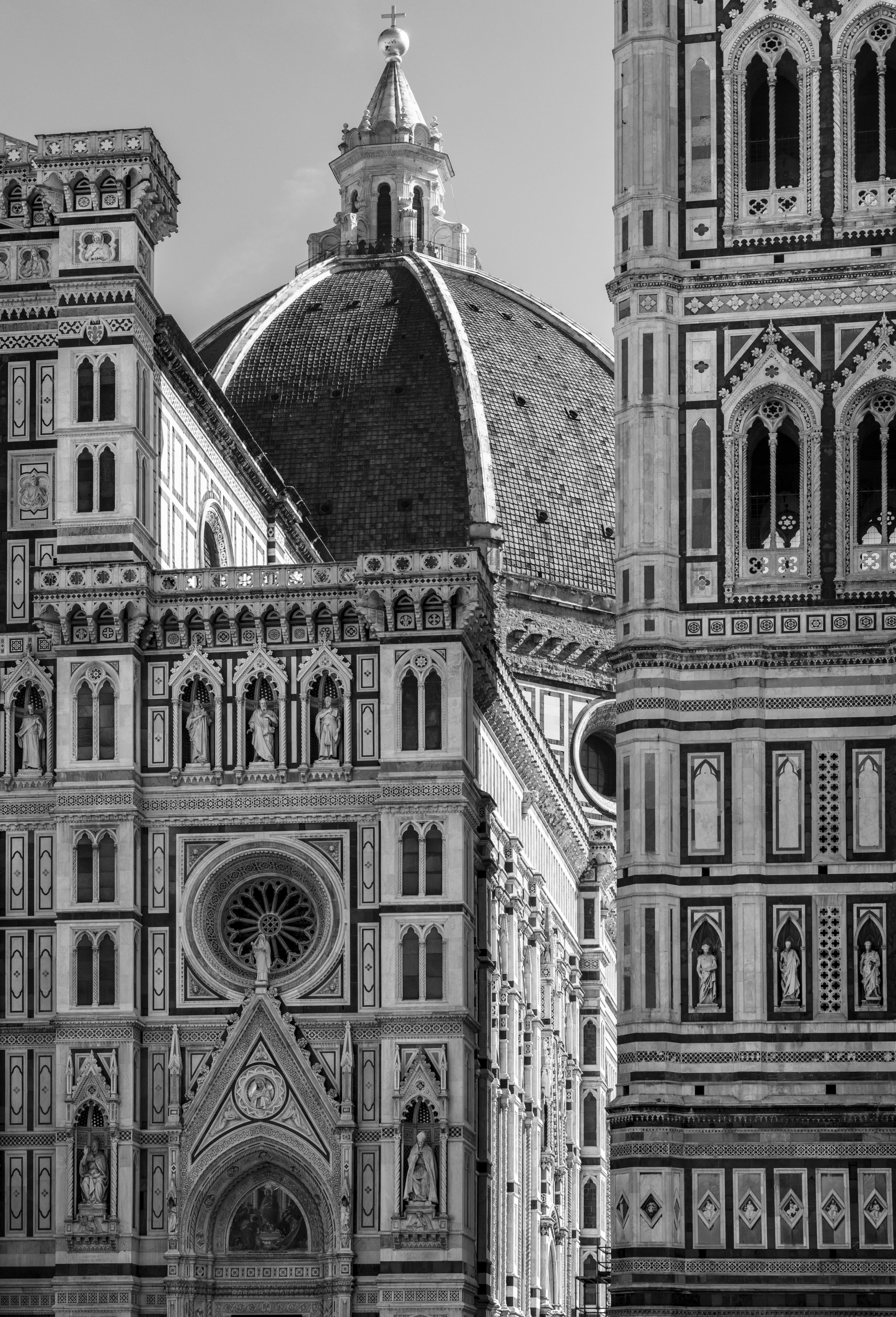 Striking black and white image of the Florence Cathedral's dome and façade, showcasing its Gothic architecture.