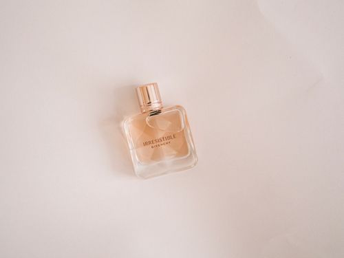 Free A sleek bottle of Irresistible Givenchy perfume on a white background, captured in a minimalist style. Stock Photo
