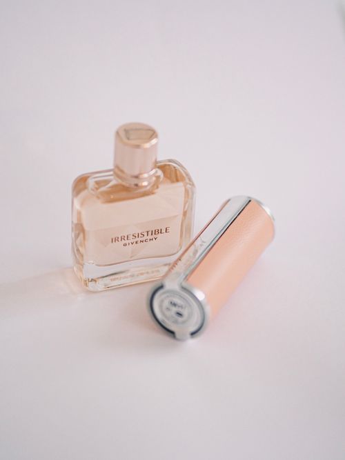 Free Stylish duo of Givenchy Irresistible perfume and lipstick on a white background, perfect for luxury beauty themes. Stock Photo