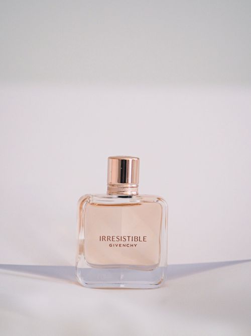 Free A stylish Givenchy perfume bottle showcased on a minimal white background. Stock Photo