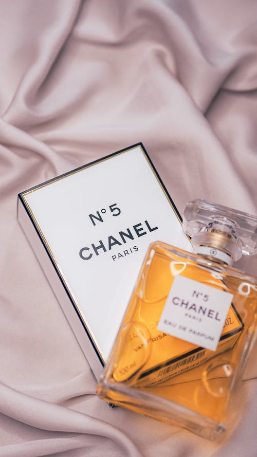 Free Chanel no 5 perfume bottle on a bed Stock Photo