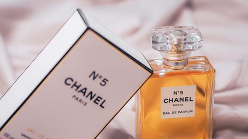 Free Chanel No.5 Eau de Parfum bottle and box beautifully displayed in a soft setting. Stock Photo