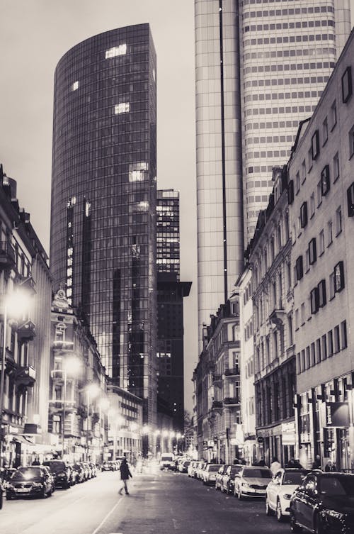 Black and white photo of city street with tall buildings